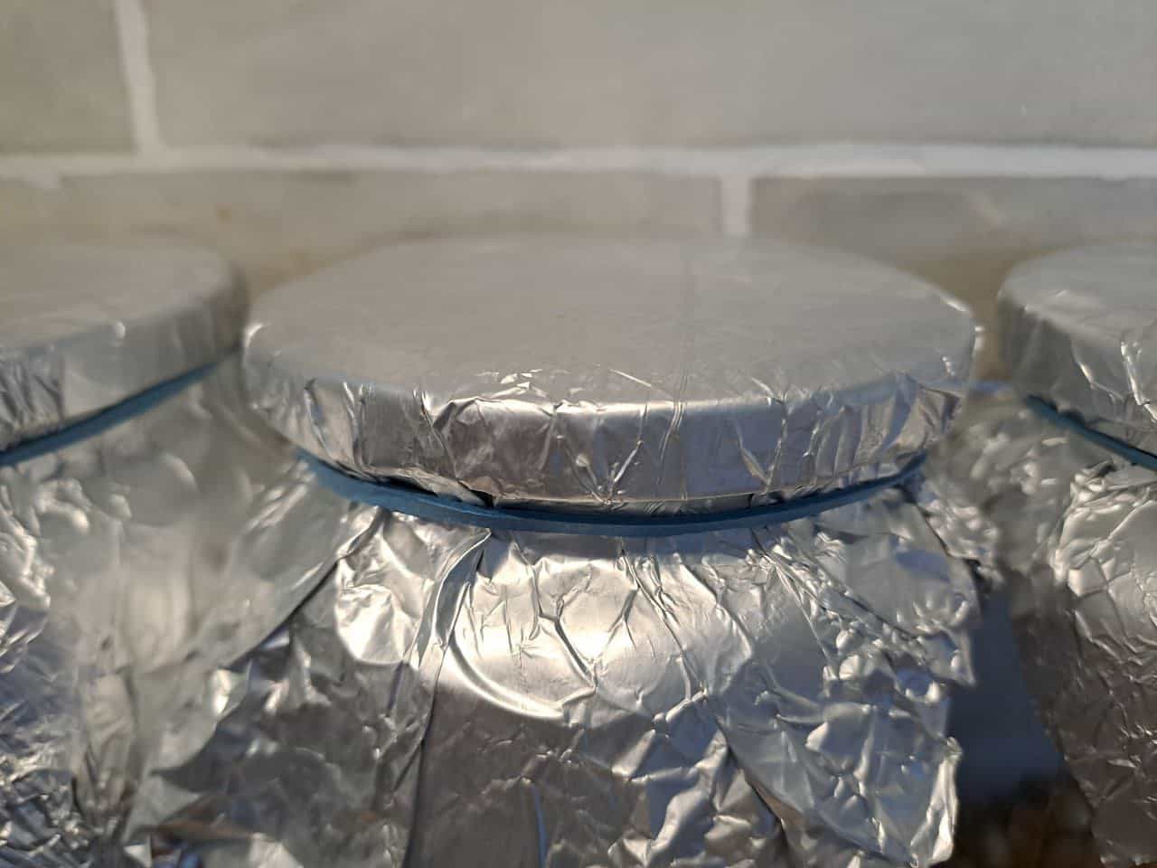 Tin foil wrapped around grain jar for mushroom spawn